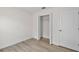 A bedroom with a closet, wood floors, white walls and trim, and a white door at 12917 Grovehurst Ave, Winter Garden, FL 34787
