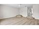 Bright bonus room with hardwood floors, tiered platform and doorway to hallway and bathroom at 12917 Grovehurst Ave, Winter Garden, FL 34787