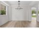 Bright dining room features a modern light fixture, neutral walls, and vinyl floors, perfect for entertaining at 12917 Grovehurst Ave, Winter Garden, FL 34787
