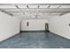 Clean and spacious garage featuring a sealed floor and ample room for storage and parking at 12917 Grovehurst Ave, Winter Garden, FL 34787