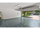 Spacious garage with sealed floors offers a glimpse of the well-maintained neighborhood outside at 12917 Grovehurst Ave, Winter Garden, FL 34787