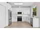 Modern kitchen with white cabinets, stainless steel appliances, and ample counter space at 12917 Grovehurst Ave, Winter Garden, FL 34787