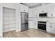 Modern kitchen features white cabinets, stainless steel appliances, and lots of counter space at 12917 Grovehurst Ave, Winter Garden, FL 34787