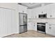 Contemporary kitchen with white cabinets, stainless steel appliances, and plenty of storage at 12917 Grovehurst Ave, Winter Garden, FL 34787