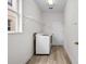 Practical laundry room with modern appliances, shelving, and ample natural light at 12917 Grovehurst Ave, Winter Garden, FL 34787