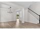 Spacious living area features a modern light fixture, and freshly painted walls creating a versatile space at 12917 Grovehurst Ave, Winter Garden, FL 34787