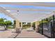 A covered patio area with outdoor seating and landscaping beside the fenced-in pool, near the playground and lake at 12917 Grovehurst Ave, Winter Garden, FL 34787