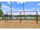 Playground swings overlooking a tranquil pond and neighborhood, offering a scenic recreational space at 12917 Grovehurst Ave, Winter Garden, FL 34787
