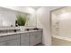 Elegant bathroom with double vanity, granite countertops, and a large walk-in shower at 1300 Isleta Loop, Kissimmee, FL 34741