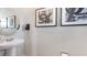 Half bath featuring pedestal sink and abstract art at 1300 Isleta Loop, Kissimmee, FL 34741