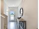 Elegant entryway featuring a console table with a mirror, offering a welcoming ambiance at 1300 Isleta Loop, Kissimmee, FL 34741