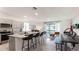 Open concept kitchen with granite countertops, stainless steel appliances, and an island with barstool seating at 1300 Isleta Loop, Kissimmee, FL 34741