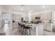 Modern kitchen features a large island with seating, stainless steel appliances, and ample cabinet space at 1300 Isleta Loop, Kissimmee, FL 34741