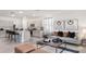 Stylish living room with modern decor and a seamless flow into the adjacent kitchen at 1300 Isleta Loop, Kissimmee, FL 34741