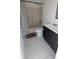 Well-lit bathroom featuring a tub-shower combo and dark vanity at 1321 Carey Glen Cir, Orlando, FL 32824