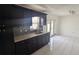 Well-lit kitchen featuring dark cabinets and modern countertops at 1321 Carey Glen Cir, Orlando, FL 32824