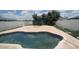 Backyard pool with a paved patio, basketball hoop, and surrounding fence at 1321 Carey Glen Cir, Orlando, FL 32824