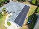Detailed aerial view of the home with solar panels, showcasing its energy efficiency and well-maintained surroundings at 1324 Saddleridge Dr, Orlando, FL 32835