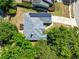 Overhead shot reveals a home with solar panels, nestled among mature trees, emphasizing privacy and sustainability at 1324 Saddleridge Dr, Orlando, FL 32835