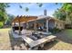Large backyard with a pergola-covered patio, outdoor seating area, and lush greenery for a private retreat at 1324 Saddleridge Dr, Orlando, FL 32835