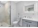Modern bathroom featuring a glass-enclosed tiled shower, gray cabinets and a lighted mirror at 1324 Saddleridge Dr, Orlando, FL 32835