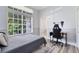 Cozy bedroom with large window with views, wood-look floors and a gaming desk area at 1324 Saddleridge Dr, Orlando, FL 32835
