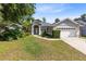 Charming home featuring a well-manicured lawn, mature landscaping, and a welcoming front entrance at 1324 Saddleridge Dr, Orlando, FL 32835