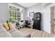 Bright home office featuring a large window, modern desk, and comfortable seating area at 1324 Saddleridge Dr, Orlando, FL 32835
