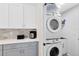 Efficient laundry room with stacked washer and dryer and plenty of storage space at 1324 Saddleridge Dr, Orlando, FL 32835