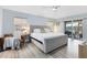 Relaxing main bedroom with gray wood floors, a ceiling fan, and a sliding glass door to the patio at 1324 Saddleridge Dr, Orlando, FL 32835
