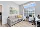 Relaxing office space featuring wood-look floors, modern wall art and a comfortable sofa at 1324 Saddleridge Dr, Orlando, FL 32835