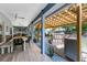 Spacious outdoor patio featuring a pergola, outdoor kitchen, and ample seating for entertaining at 1324 Saddleridge Dr, Orlando, FL 32835