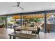 Inviting covered patio with an outdoor kitchen, dining area, and pergola-covered space for relaxing at 1324 Saddleridge Dr, Orlando, FL 32835