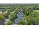 Aerial view of the neighborhood with mature trees and gray roofs at 1333 Killbricken Cir, Ormond Beach, FL 32174