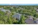 Aerial view of the house and neighborhood near the lake and mature trees at 1333 Killbricken Cir, Ormond Beach, FL 32174