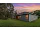 Exterior rear view showing a covered patio and a well-maintained backyard at 1333 Killbricken Cir, Ormond Beach, FL 32174