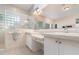Bathroom featuring dual sinks with white cabinets and a glass-enclosed shower at 1333 Killbricken Cir, Ormond Beach, FL 32174