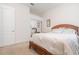 Bedroom with a mirrored closet, a bed with white bedding, and a wicker headboard at 1333 Killbricken Cir, Ormond Beach, FL 32174