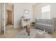 Bedroom with crib, changing table, round rug, and light-filled windows at 1333 Killbricken Cir, Ormond Beach, FL 32174