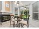 Bright dining area with tile floors, fireplace, sliding door and modern table set at 1333 Killbricken Cir, Ormond Beach, FL 32174