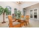 Dining room with natural lighting, rattan chairs, glass table, and large potted plant at 1333 Killbricken Cir, Ormond Beach, FL 32174