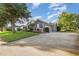 Home with a spacious driveway, two car garage and manicured landscaping at 1333 Killbricken Cir, Ormond Beach, FL 32174