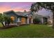 Charming exterior with stone accents, arched windows, and well-manicured lawn at 1333 Killbricken Cir, Ormond Beach, FL 32174