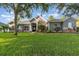Charming single-story home featuring stone accents and a well-manicured lawn at 1333 Killbricken Cir, Ormond Beach, FL 32174