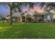 Charming home featuring stone accents, arched windows and lush green lawn at 1333 Killbricken Cir, Ormond Beach, FL 32174