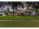 Charming home featuring stone accents, arched windows and lush green lawn at 1333 Killbricken Cir, Ormond Beach, FL 32174