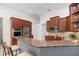Open-concept kitchen with granite countertops, stainless steel appliances, and a breakfast bar for casual dining at 1333 Killbricken Cir, Ormond Beach, FL 32174