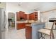 Stylish kitchen featuring cherry wood cabinets, granite countertops, stainless steel appliances, and tiled backsplash at 1333 Killbricken Cir, Ormond Beach, FL 32174