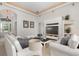 Bright living room with tall ceilings, plush white sofas, and a decorative fireplace at 1333 Killbricken Cir, Ormond Beach, FL 32174
