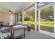 Cozy screened-in patio featuring modern outdoor furniture, a ceiling fan, and a view of the green backyard at 1333 Killbricken Cir, Ormond Beach, FL 32174